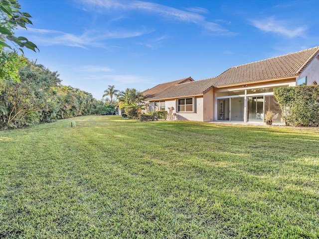 view of yard with a sunroom