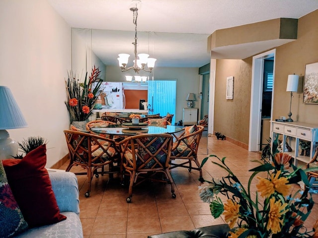 tiled dining space with a chandelier