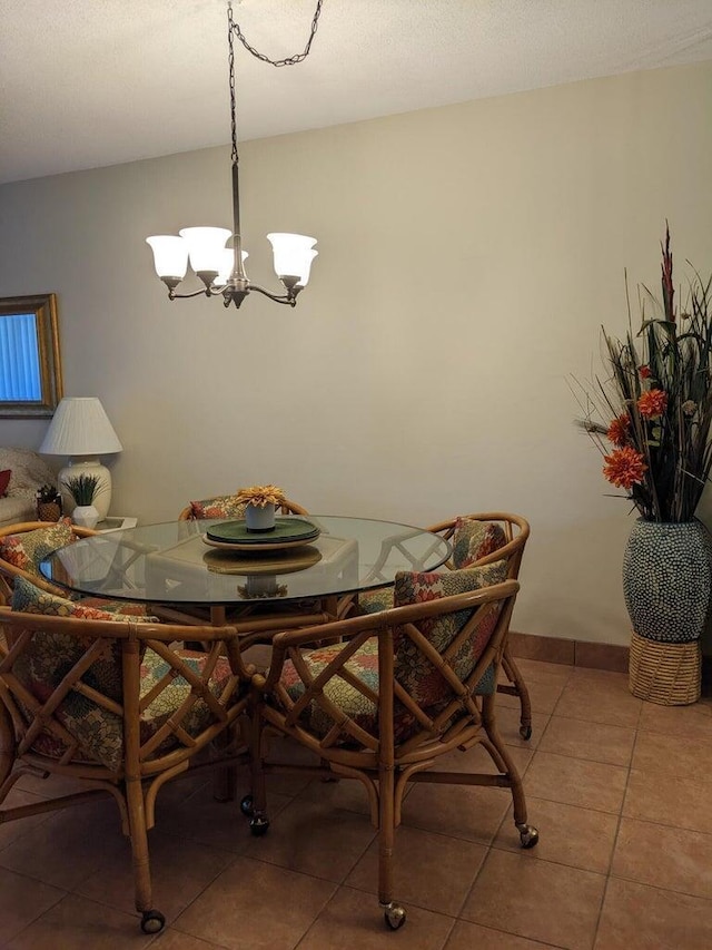 tiled dining area featuring a chandelier