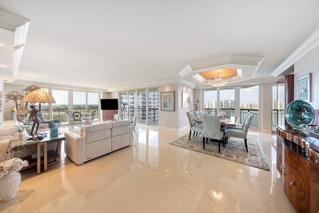 living room with a notable chandelier, a wall of windows, a raised ceiling, and crown molding