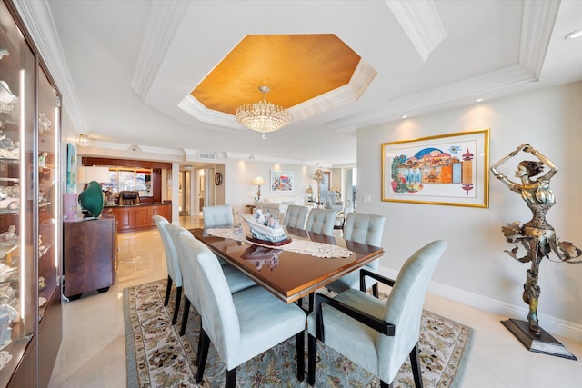 dining area with light tile patterned floors, crown molding, a chandelier, and a tray ceiling