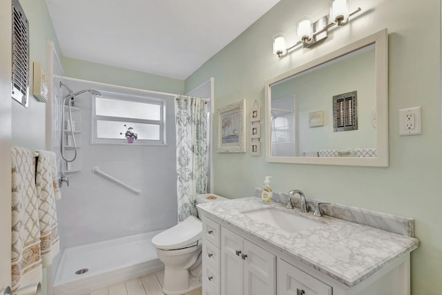 bathroom featuring curtained shower, toilet, and vanity