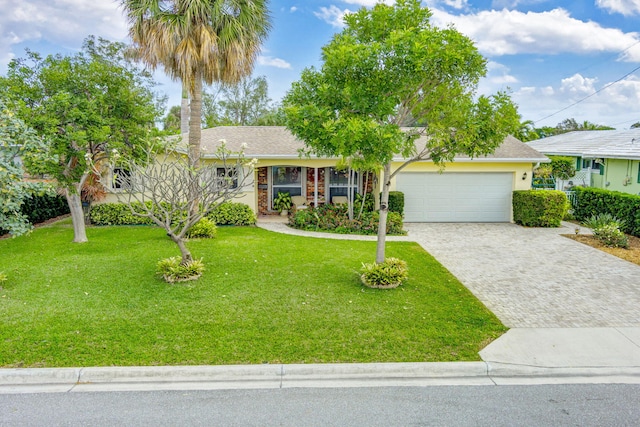 view of front of property with a garage and a front yard