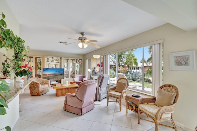 tiled living room with ceiling fan and a wealth of natural light