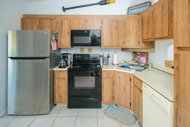 kitchen with sink, light tile patterned floors, and black appliances