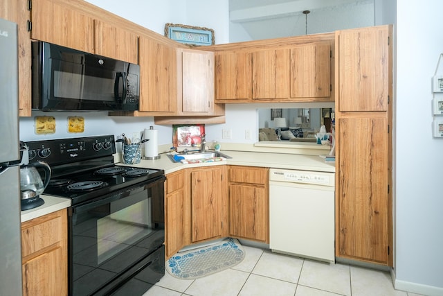 kitchen featuring black appliances, light tile patterned flooring, and sink