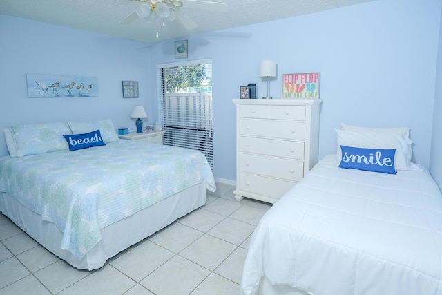 tiled bedroom with a textured ceiling and ceiling fan