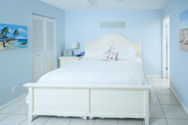 bedroom featuring a closet and light tile patterned flooring