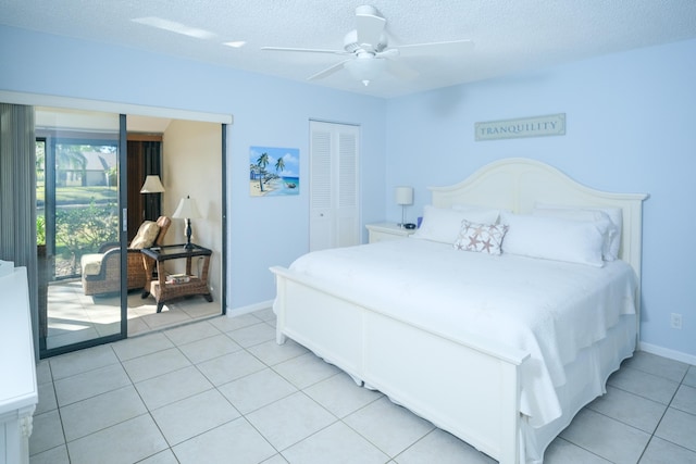 bedroom with light tile patterned floors, a textured ceiling, a closet, and ceiling fan