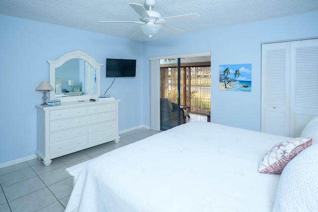 tiled bedroom featuring a textured ceiling, a closet, and ceiling fan