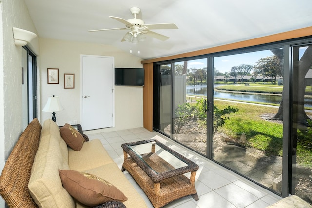 tiled living room featuring ceiling fan and lofted ceiling