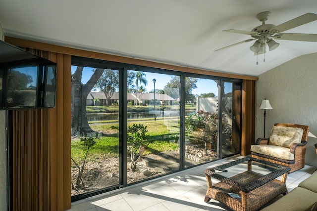 doorway to outside with ceiling fan, a water view, and light tile patterned floors