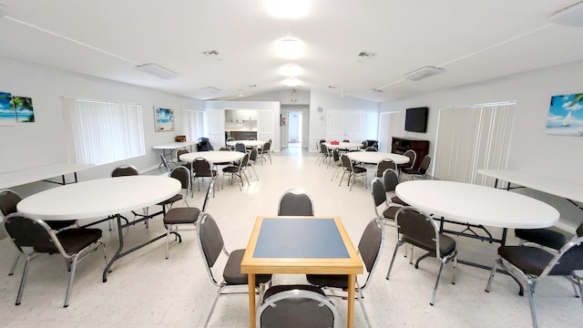 dining space featuring lofted ceiling