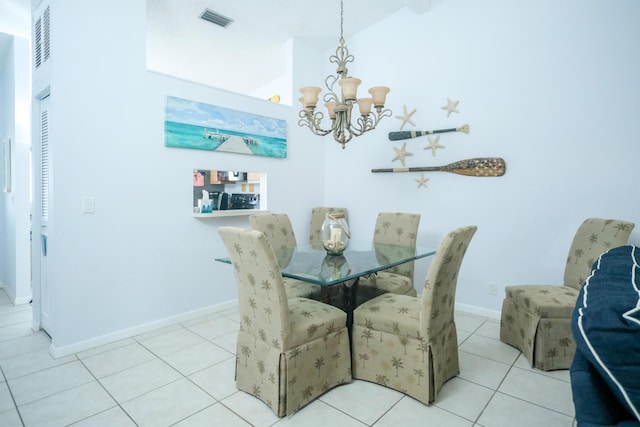 tiled dining space featuring lofted ceiling and a chandelier