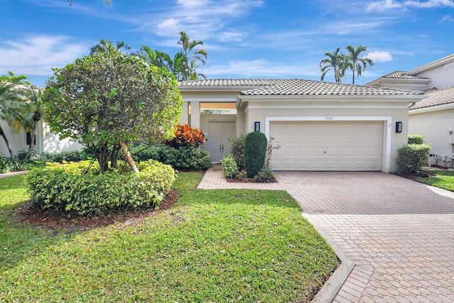 view of front of home with a front yard and a garage