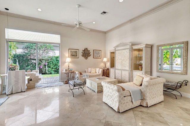 living room featuring ceiling fan and crown molding