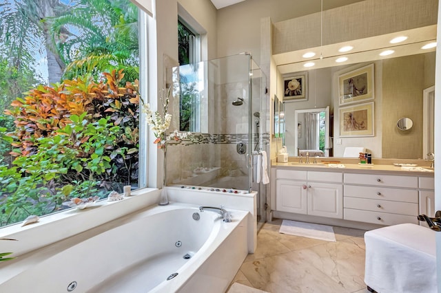 bathroom with vanity, plenty of natural light, and separate shower and tub