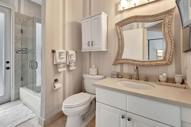 full bathroom with combined bath / shower with glass door, tile patterned flooring, vanity, and toilet