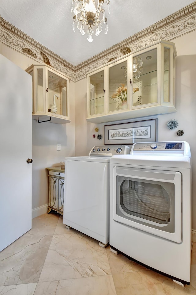 laundry room with a chandelier and washer and clothes dryer