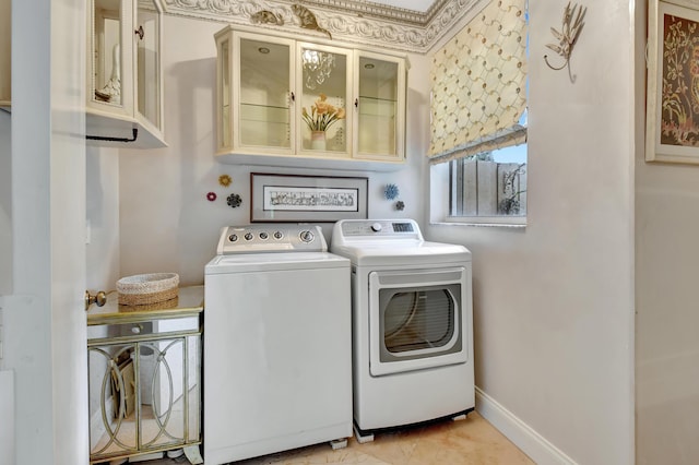 laundry area featuring washing machine and dryer and light tile patterned floors