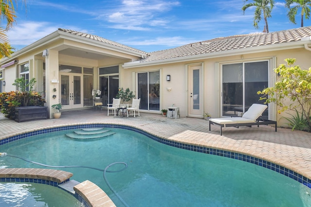 view of swimming pool with french doors and a patio area