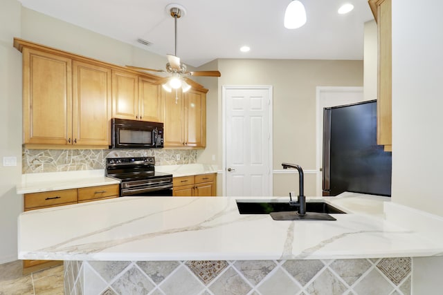 kitchen with black appliances, backsplash, kitchen peninsula, and sink