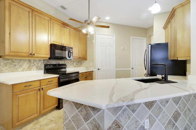 kitchen featuring sink, hanging light fixtures, tasteful backsplash, kitchen peninsula, and black appliances