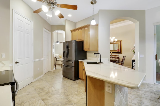 kitchen featuring light brown cabinetry, ceiling fan with notable chandelier, sink, pendant lighting, and stainless steel fridge with ice dispenser