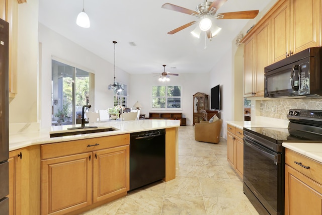 kitchen featuring ceiling fan, sink, hanging light fixtures, and black appliances