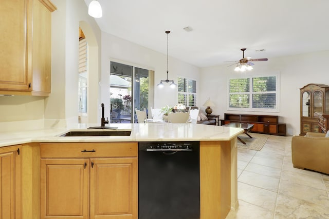 kitchen featuring ceiling fan, dishwasher, sink, hanging light fixtures, and kitchen peninsula