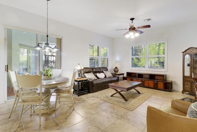 living room featuring ceiling fan and french doors