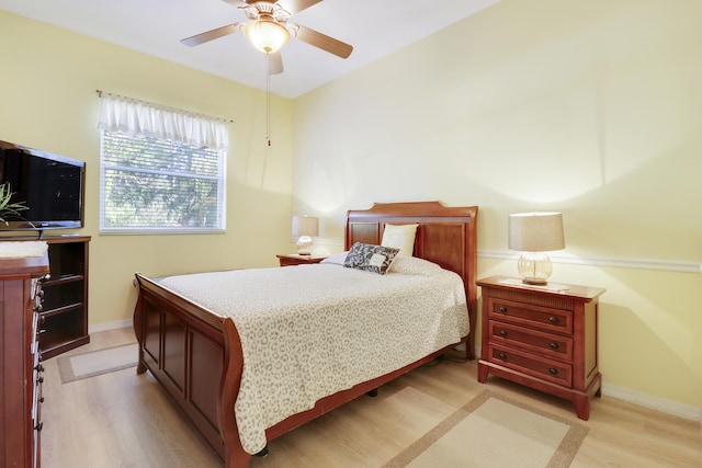 bedroom with light hardwood / wood-style flooring and ceiling fan