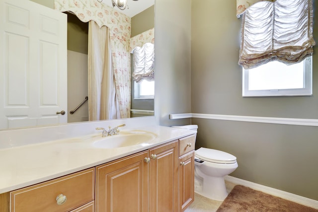 bathroom featuring tile patterned floors, vanity, and toilet