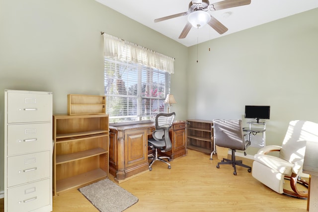 home office featuring light hardwood / wood-style floors and ceiling fan