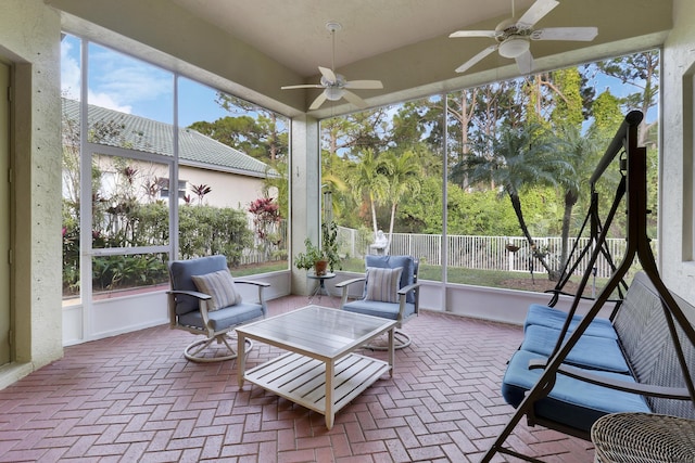 sunroom featuring ceiling fan