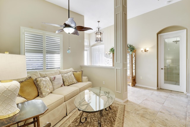 living room featuring ceiling fan and lofted ceiling