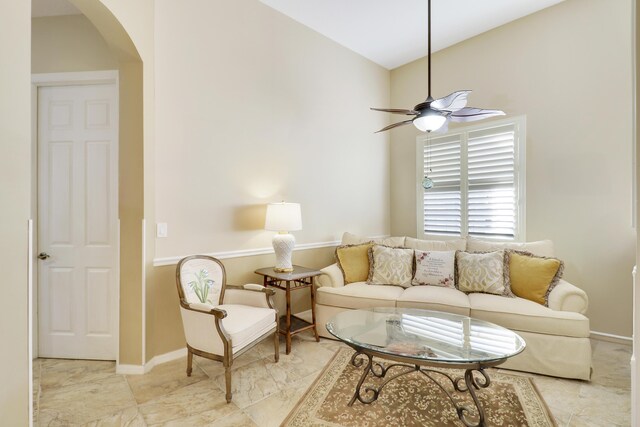 living room with ceiling fan and vaulted ceiling