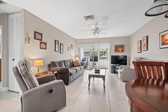 living room featuring ceiling fan and light tile patterned flooring