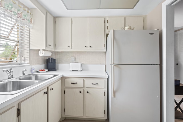 kitchen with sink and white fridge