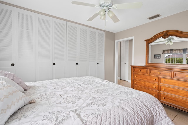 tiled bedroom with ceiling fan