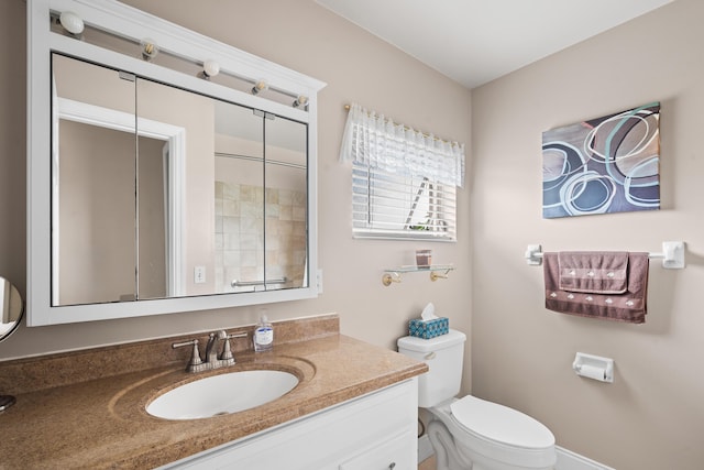 bathroom with toilet and vanity