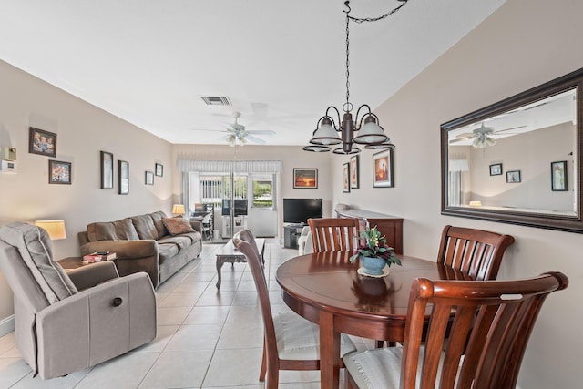 dining area with light tile patterned floors and a chandelier