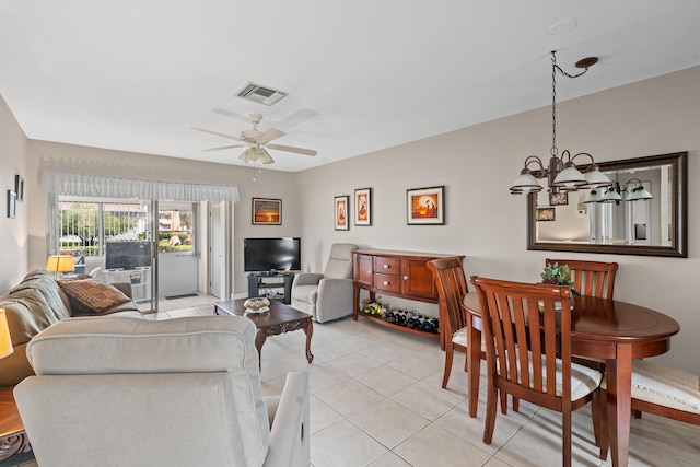 living room with ceiling fan with notable chandelier and light tile patterned floors