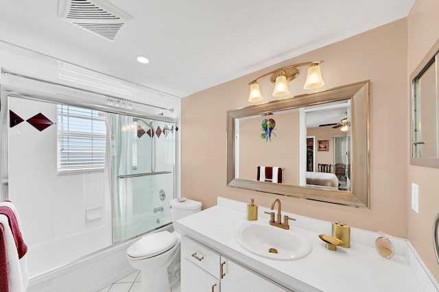 full bathroom featuring ceiling fan, tile patterned flooring, enclosed tub / shower combo, toilet, and vanity