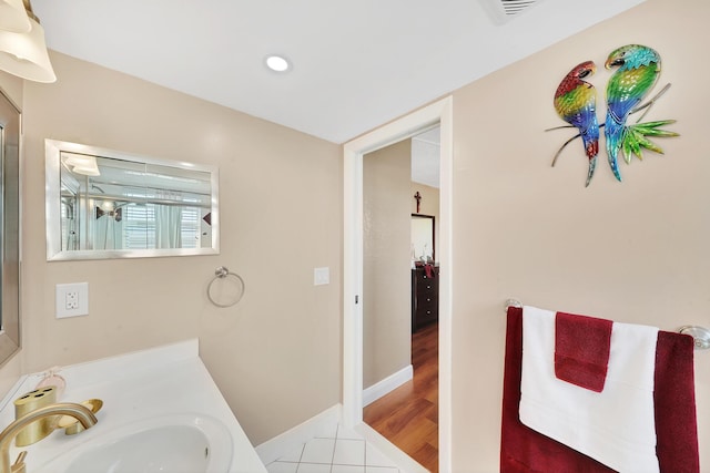 bathroom featuring tile patterned flooring and vanity