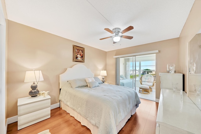 bedroom featuring access to outside, ceiling fan, and hardwood / wood-style floors