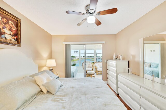 bedroom with wood-type flooring, access to outside, and ceiling fan