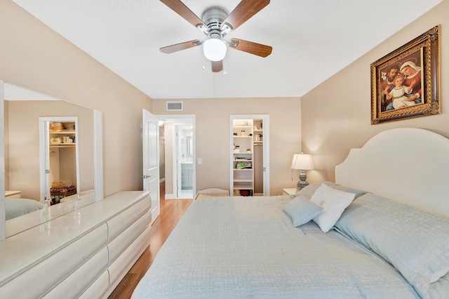 bedroom featuring ensuite bath, a spacious closet, and a closet