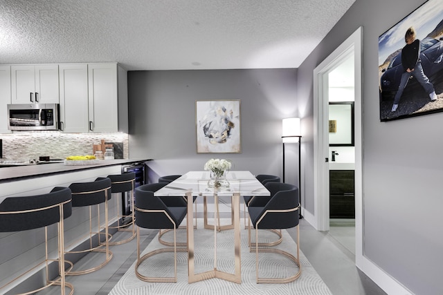 dining space featuring a textured ceiling