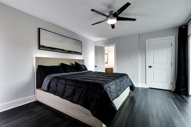 bedroom with ceiling fan, ensuite bath, dark hardwood / wood-style flooring, and a textured ceiling